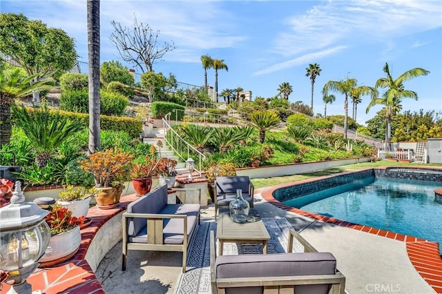 outdoor pool featuring fence, a patio, and an outdoor hangout area