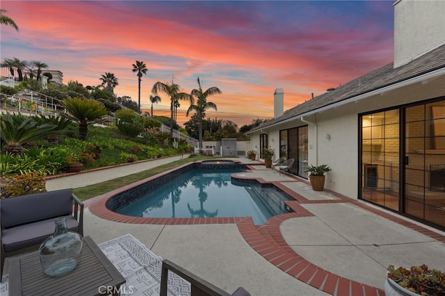 view of pool with a pool with connected hot tub and a patio area