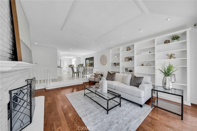21 Santa Catalina Dr, Rancho Palos Verdes, CA 90275 - living room with wood finished floors, built in shelves, a brick fireplace, attic access, and recessed lighting