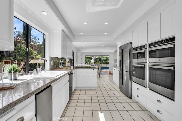 21 Santa Catalina Dr, Rancho Palos Verdes, CA 90275 - kitchen with a sink, stainless steel appliances, light tile patterned flooring, a peninsula, and recessed lighting