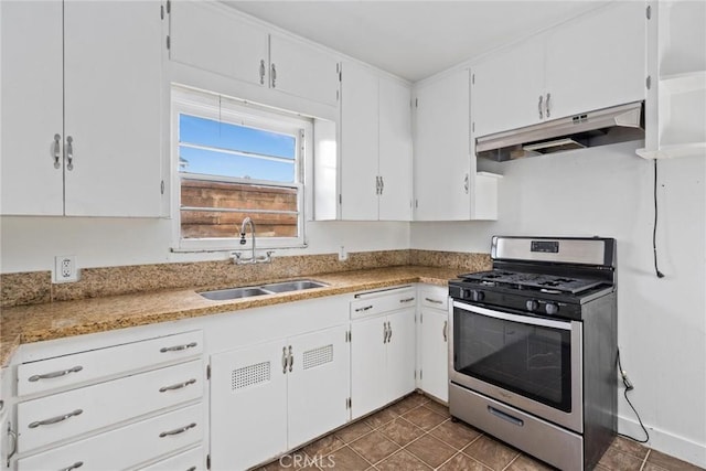 kitchen featuring under cabinet range hood, a sink, white cabinets, light countertops, and stainless steel range with gas cooktop