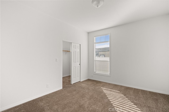 unfurnished bedroom featuring a closet, carpet, and baseboards