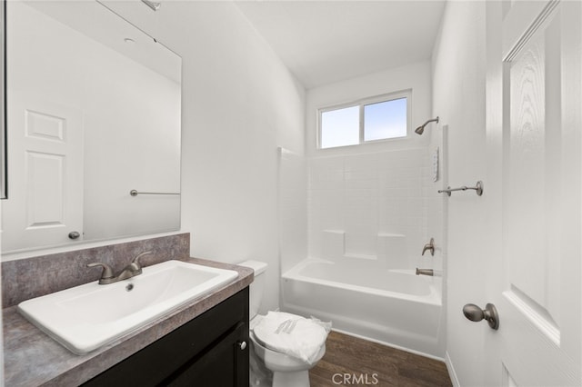 bathroom featuring toilet, shower / bathtub combination, wood finished floors, and vanity