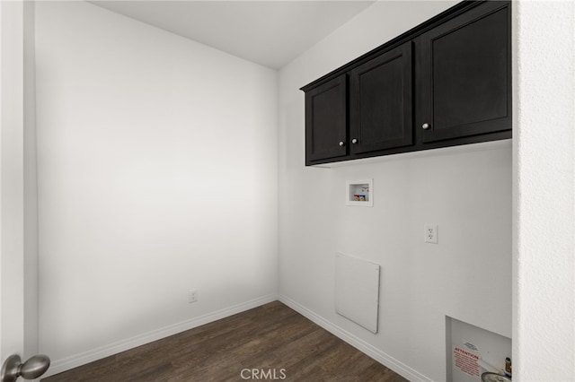 clothes washing area with cabinet space, baseboards, washer hookup, and dark wood finished floors