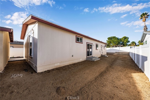 rear view of house featuring crawl space and a fenced backyard