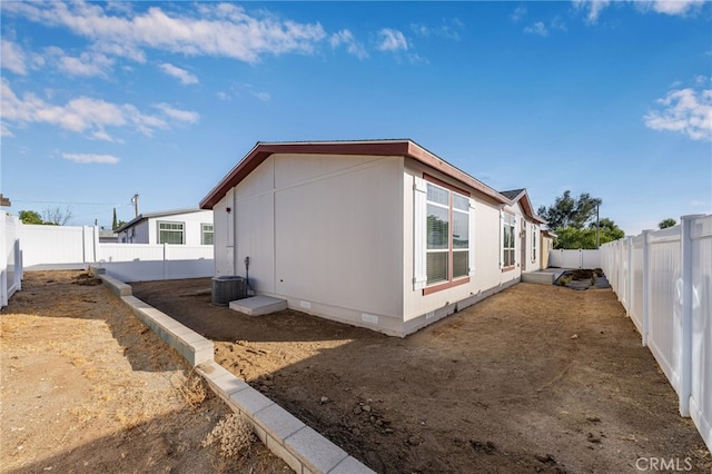 view of property exterior featuring crawl space, a fenced backyard, and central AC unit