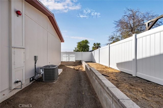 view of yard featuring central AC and a fenced backyard