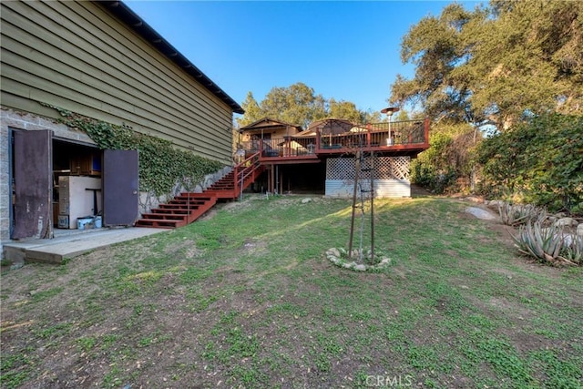 view of yard featuring stairway and a deck