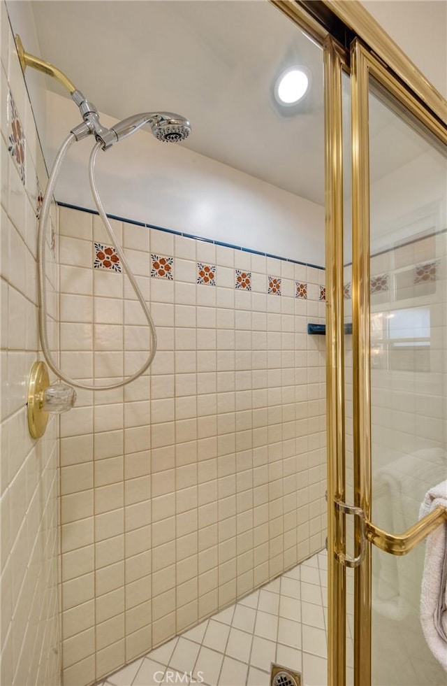 full bathroom with a shower stall and tile patterned floors