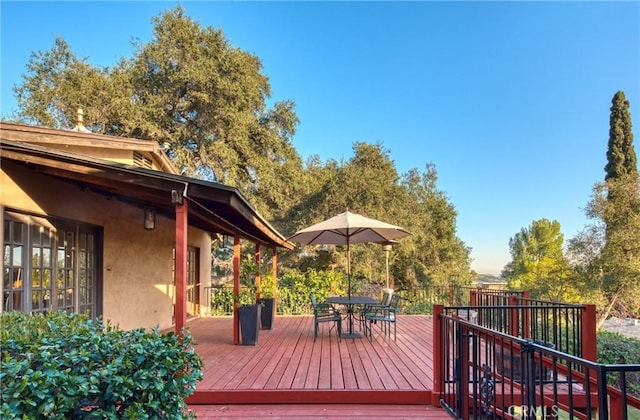 wooden deck featuring outdoor dining area