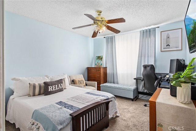 carpeted bedroom featuring a ceiling fan and a textured ceiling