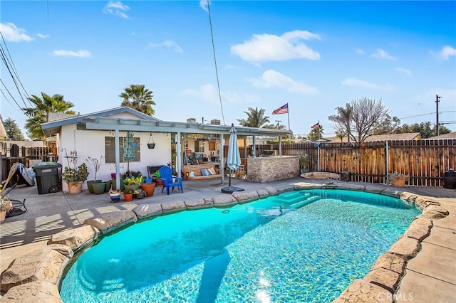 view of swimming pool featuring a fenced backyard, outdoor dry bar, a fenced in pool, and a patio