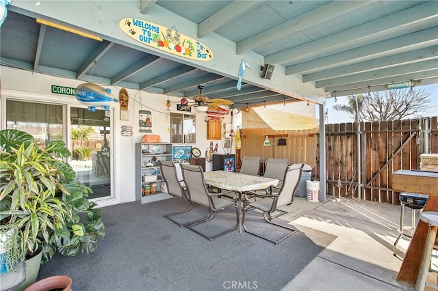 view of patio featuring outdoor dining area and fence