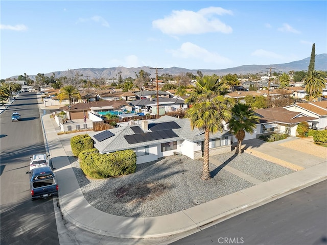 drone / aerial view featuring a residential view and a mountain view