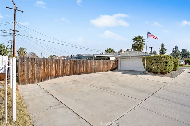 view of side of property with a garage and fence