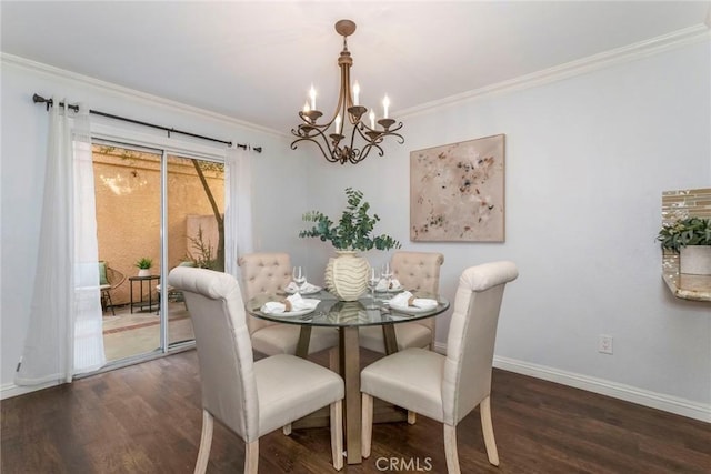 dining space featuring baseboards, an inviting chandelier, wood finished floors, and crown molding