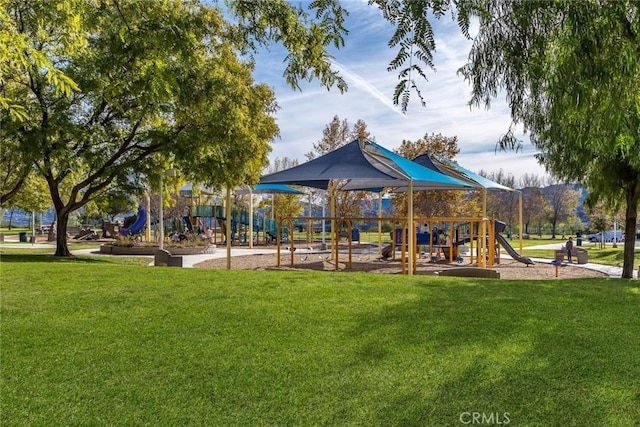 community jungle gym featuring a yard