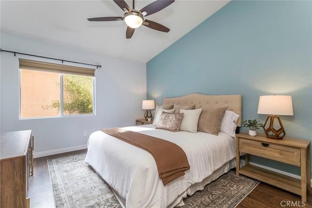 bedroom with lofted ceiling, a ceiling fan, baseboards, and wood finished floors