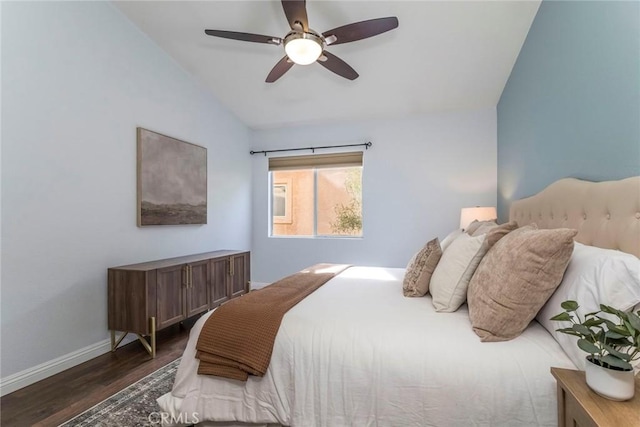 bedroom with ceiling fan, vaulted ceiling, baseboards, and wood finished floors