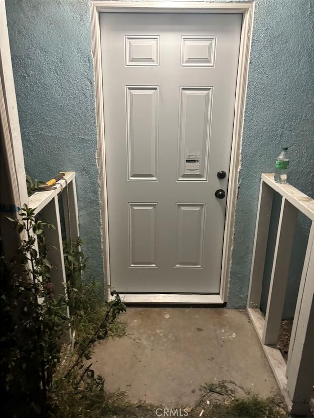 doorway to property with stucco siding