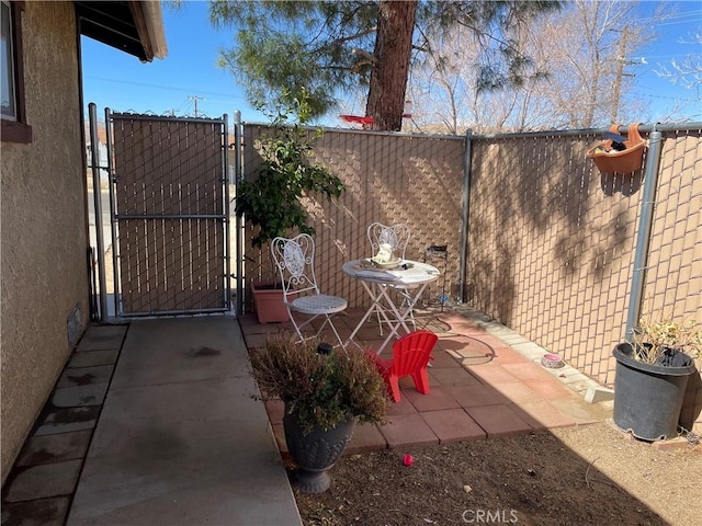 view of patio / terrace with a gate and fence