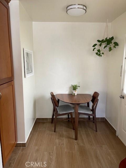 dining room featuring baseboards and wood finished floors