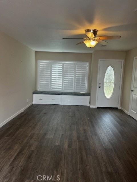 foyer featuring dark wood-style flooring, a ceiling fan, and baseboards