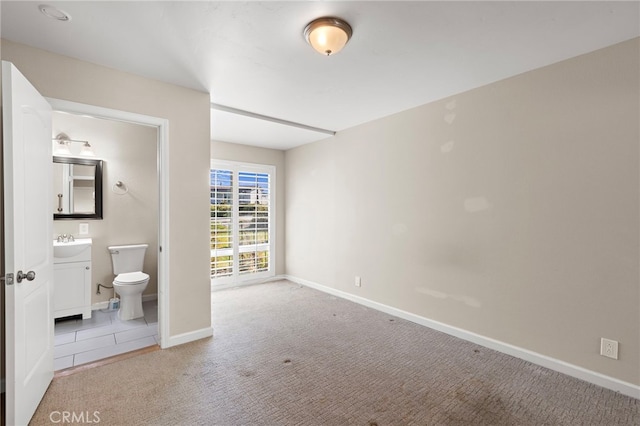 3902 Vista Campana N Unit 45, Oceanside, CA 92057 - unfurnished bedroom with connected bathroom, baseboards, light colored carpet, and a sink