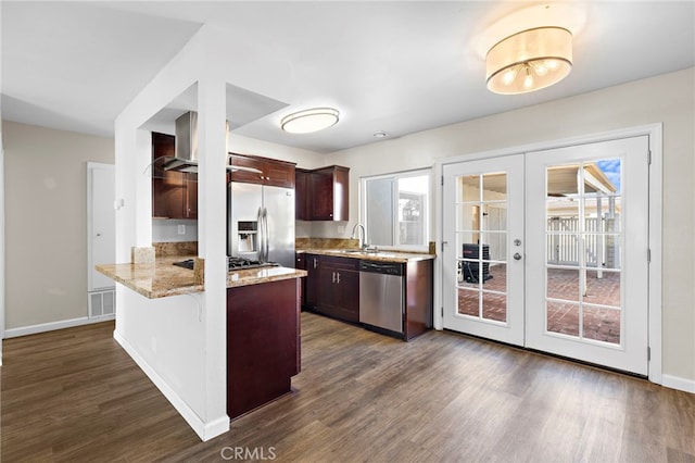 3902 Vista Campana N Unit 45, Oceanside, CA 92057 - kitchen with french doors, appliances with stainless steel finishes, a sink, a peninsula, and dark wood-type flooring