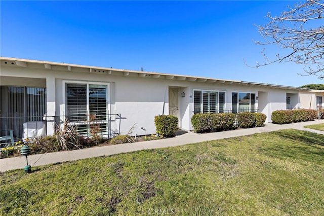 3902 Vista Campana N Unit 45, Oceanside, CA 92057 - view of front of house with stucco siding and a front yard
