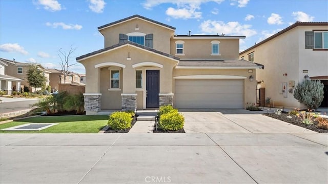 mediterranean / spanish-style house with solar panels, stucco siding, an attached garage, stone siding, and driveway