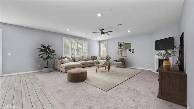 living room with a fireplace, recessed lighting, visible vents, ceiling fan, and baseboards