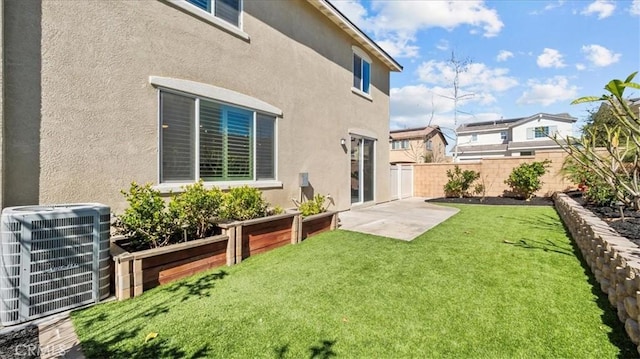 view of yard with central AC, a patio area, and fence