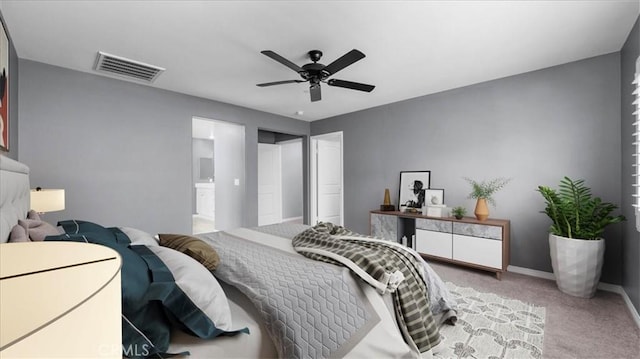 carpeted bedroom with ceiling fan, ensuite bathroom, visible vents, and baseboards