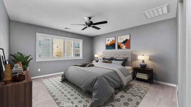 bedroom with light carpet, a ceiling fan, visible vents, and baseboards