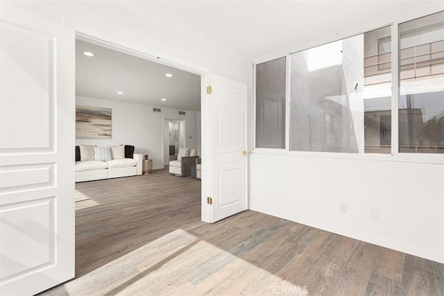 unfurnished room featuring recessed lighting and wood finished floors