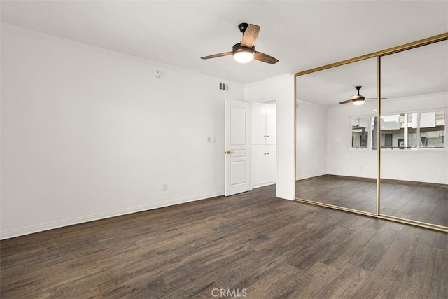 unfurnished bedroom featuring ceiling fan, a closet, ornamental molding, and wood finished floors