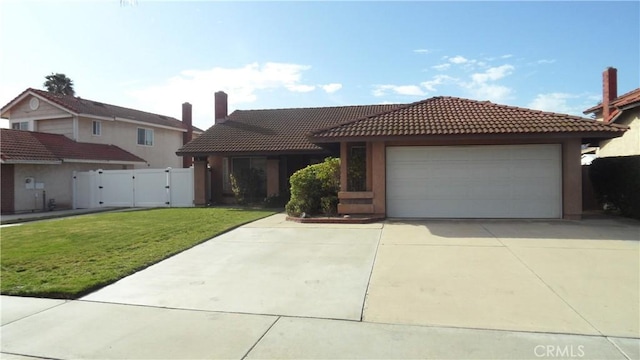 view of front of property with a garage, driveway, a tile roof, a gate, and a front yard