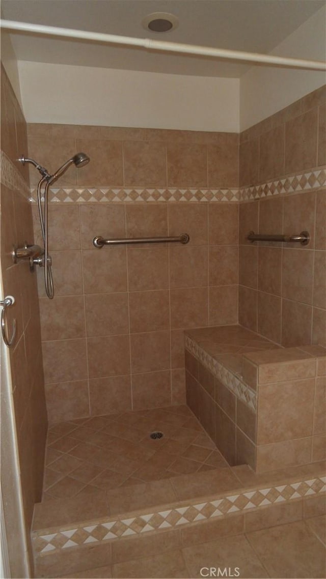 full bathroom with a tile shower