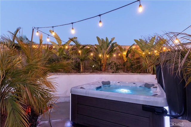 view of swimming pool featuring a hot tub and a fenced backyard