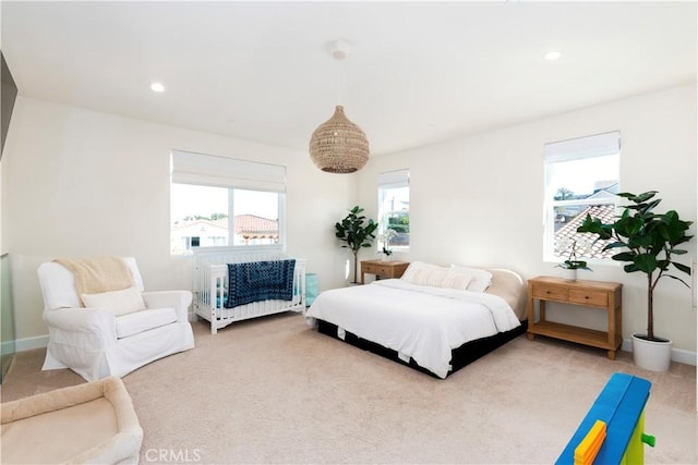 carpeted bedroom featuring baseboards and recessed lighting