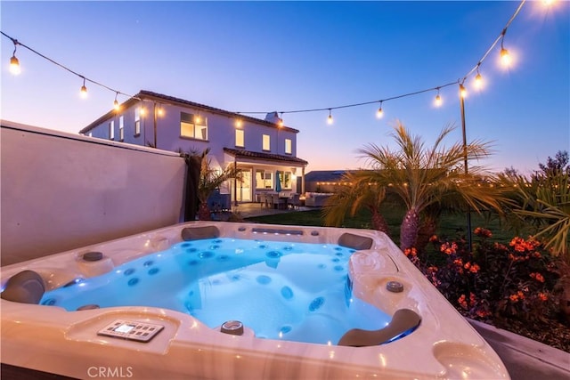 view of swimming pool featuring a patio area and a hot tub