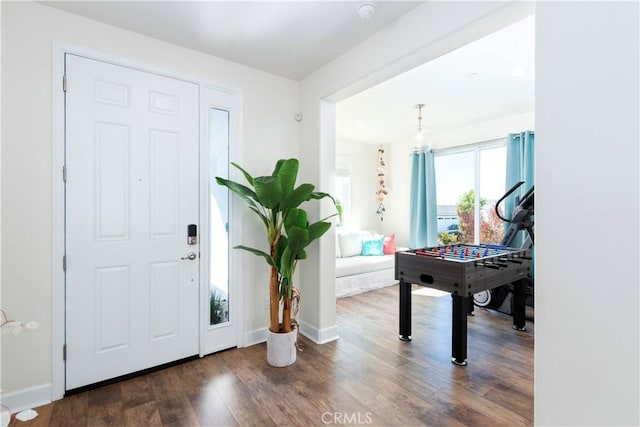 foyer entrance featuring baseboards and wood finished floors