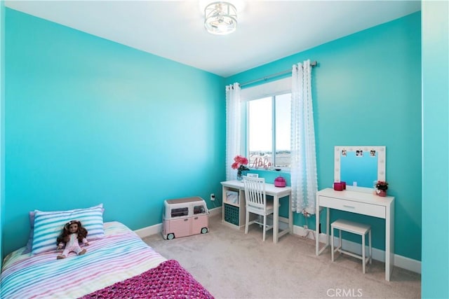 carpeted bedroom featuring baseboards