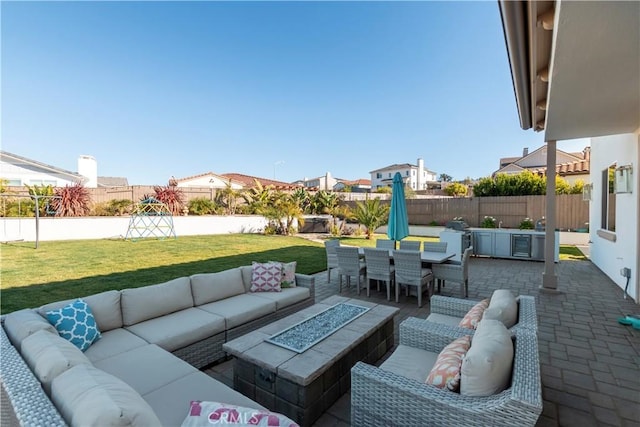 view of patio featuring outdoor dining area, an outdoor living space with a fire pit, and a fenced backyard