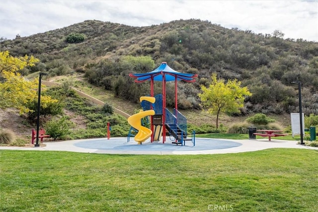 community playground featuring a lawn and a mountain view