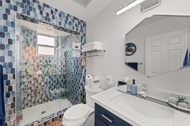 bathroom with visible vents, a shower stall, toilet, and vanity