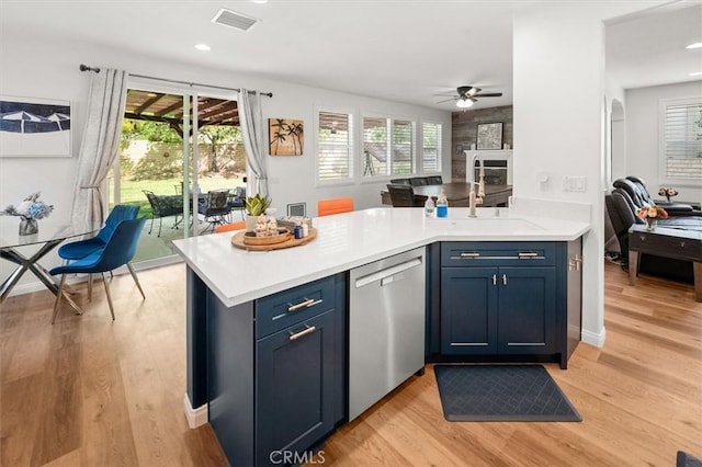 kitchen with light wood-style floors, visible vents, light countertops, and dishwasher