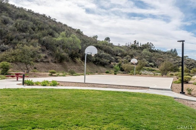 view of sport court with community basketball court and a lawn