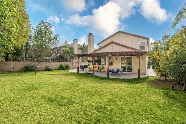 rear view of property featuring a yard, stucco siding, a patio area, fence, and a pergola